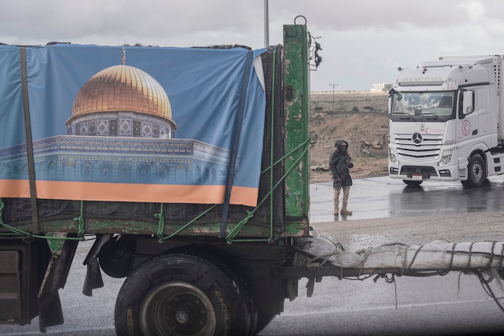 Trucks carrying humanitarian aid line up to cross Rafah crossing port on their way to Gaza Strip, in Rafah, Egypt, Monday, Nov. 27, 2023. (AP)