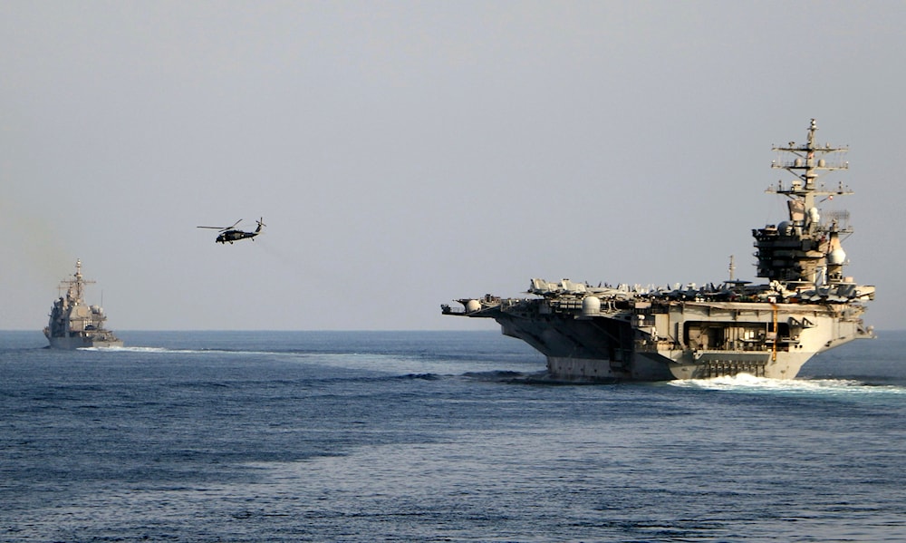 The aircraft carrier USS Dwight D. Eisenhower and other warships crosses the Strait of Hormuz into the Persian Gulf on Sunday, Nov. 26, 2023 (AP)