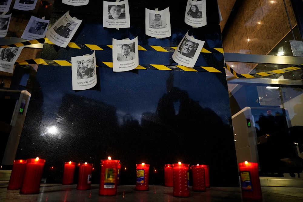Photos of slain journalists are displayed on a wall during a vigil outside Mexico's Attorney General's office in Mexico City, Wednesday, Aug. 24, 2022 (AP)