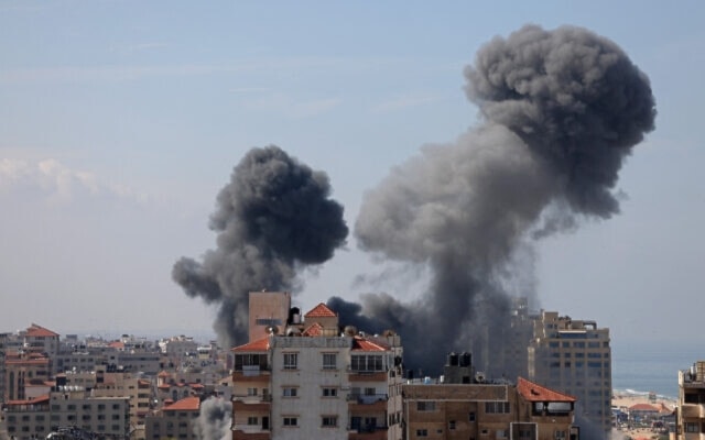 Smoke billows from a residential building following an Israeli airstrike in Gaza City on October 7, 2023. (AFP)