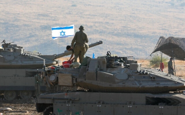 Israeli tanks are positioned in the occupied Palestinian territories near the border with Lebanon on October 15, 2023. (AFP)