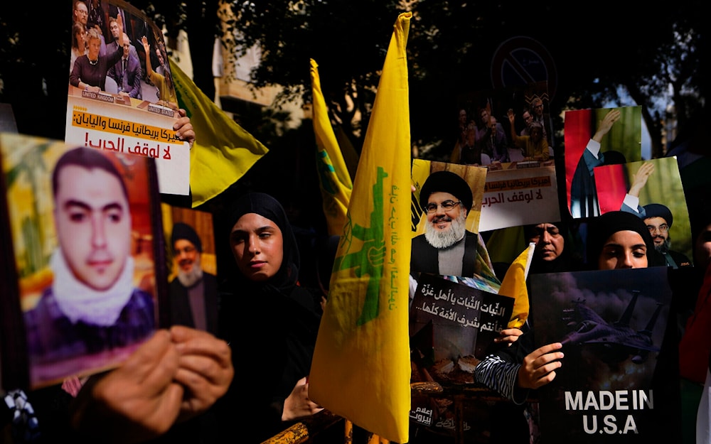 Hezbollah supporters hold flags and portraits of terror leader Hassan Nasrallah in Beirut, Lebanon Oct. 18, 2023. (AP)