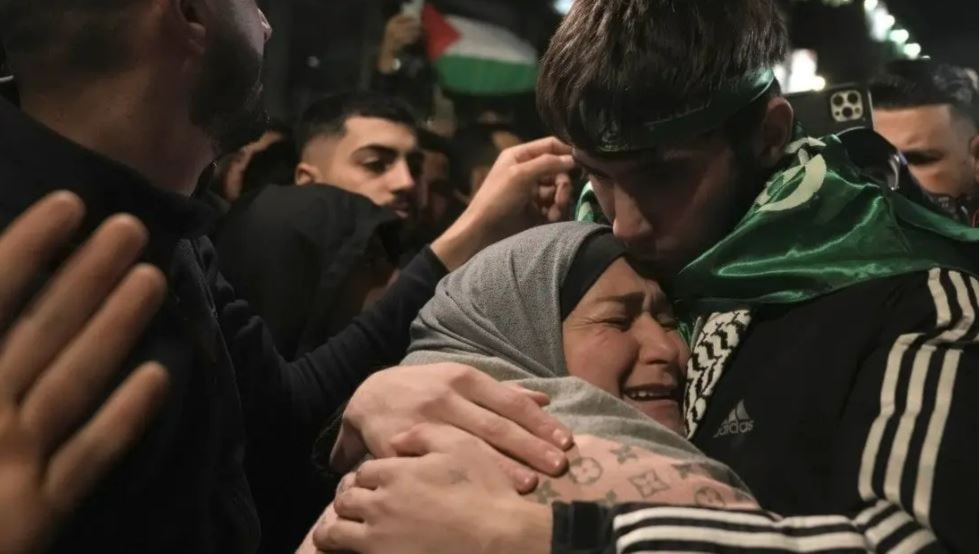 Palestinian child Omar Atshan,17, is hugged by his mother after being released from an Israeli prison in the West Bank town of Ramallah, Sunday Nov. 26, 2023. (AP)