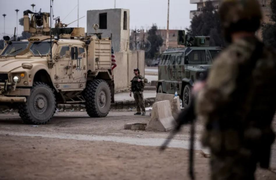 US occupation soldiers stand guard in northeast Syria, on January 27, 2022 (AP)