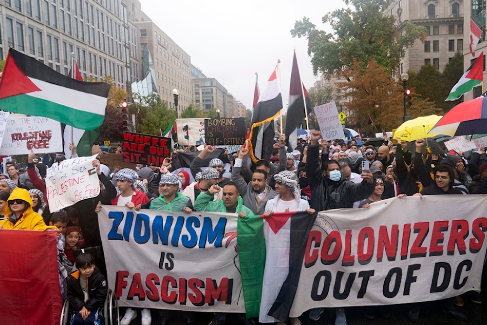 Demonstrators march in support of Palestine towards the White House in Washington, October 14, 2023 (AP)