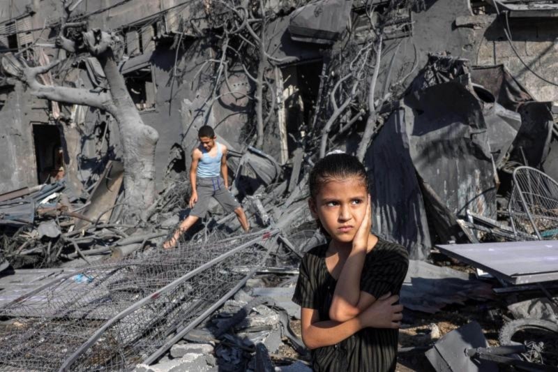 A girl looks on as she stands by the rubble outside a building that was hit by Israeli bombardment in Rafah in the southern Gaza Strip on October 31, 2023. (AFP)