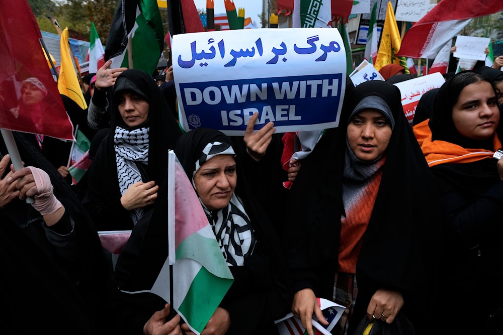 An Iranian demonstrator holds an anti-Israeli placard during a rally in front of the former U.S. Embassy in Tehran, Iran, on Saturday, Nov. 4, 2023. (AP)