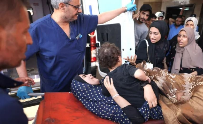 A wounded Palestinian woman and her child are wheeled into the Nasser hospital following Israeli bombardment, in Khan Younis, in the southern Gaza Strip on October 26 (AFP)