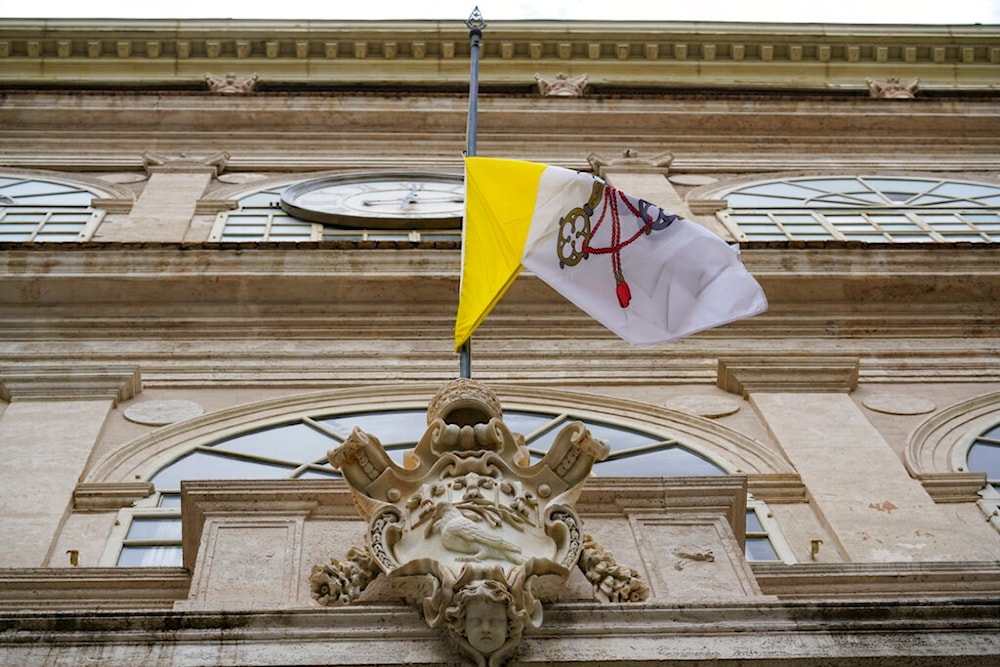 Vatican flag flies at half-staff during a minute of silence, at the Vatican's Apostolic Palace, Tuesday, March 31, 2020 (AP)