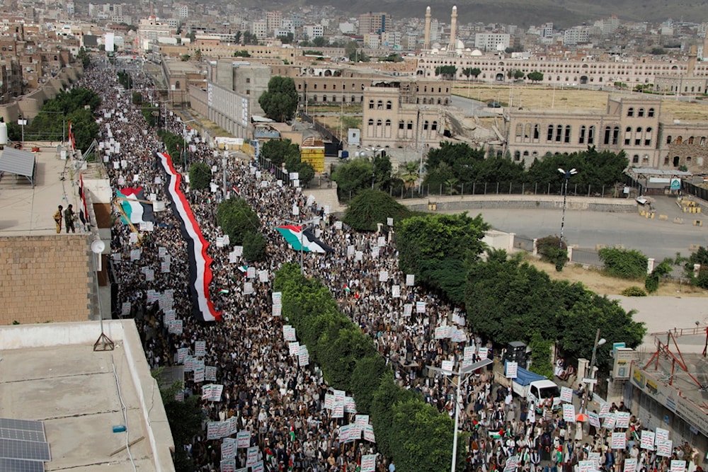 Protesters hold a representation of the Yemeni and Palestinian flags during a rally in Sanaa, Yemen, July 4, 2023 (AP)