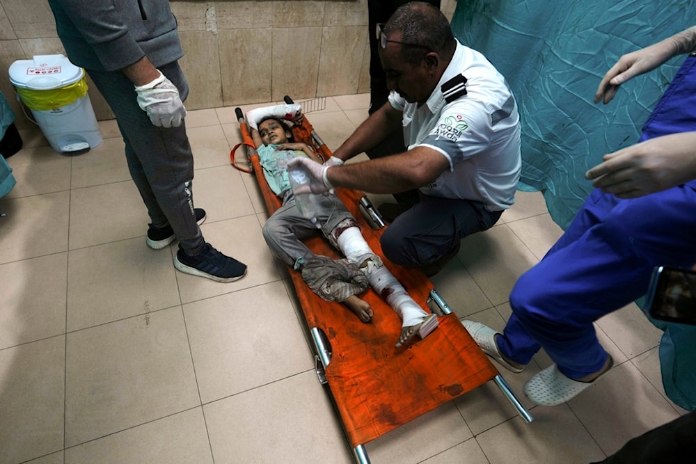 Palestinian child wounded in the Israeli bombardment of the Gaza Strip is brought to a treatment room of al Aqsa Hospital in Deir al Balah on Deir al Balah, Sunday, Nov. 5, 2023 (AP Photo/Adel Hana)