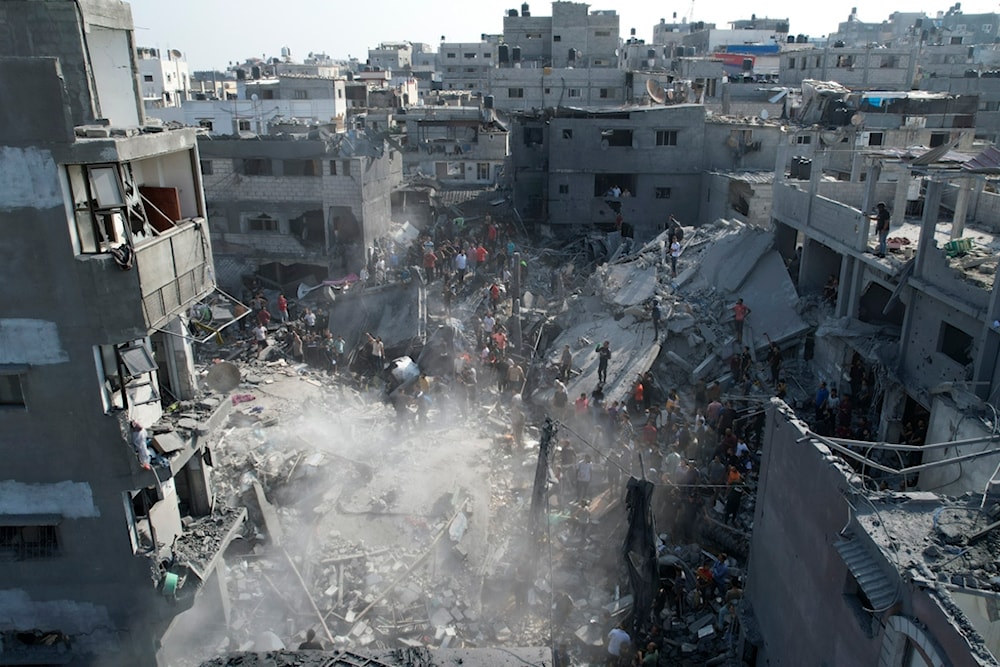 Palestinians look for survivors of the Israeli bombardment in the Maghazi refugee camp in the Gaza Strip, occupied Palestine, November 5, 2023 (AP)