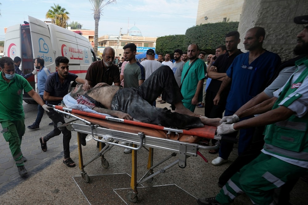A Palestinian wounded in the Israeli bombardment of the Gaza Strip is brought to a treatment room of al Aqsa Hospital in Deir al Balah, Gaza, occupied Palestine, Oct. 31, 2023 (AP)