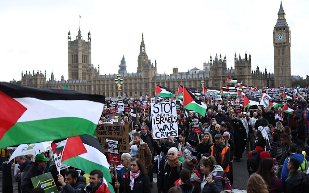 Pro-Palestinian, anti-Israel protesters walk over Westminster Bridge, near the Houses of Parliament, during a 'March For Palestine' in London on October 28, 2023. (AFP)