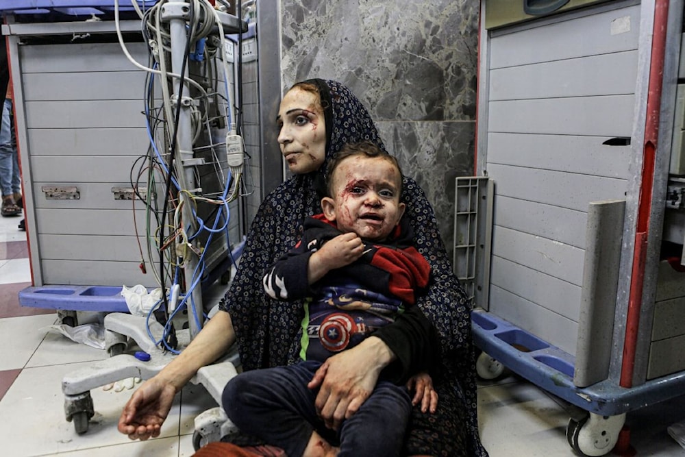 A woman and her child wounded in a hospital in Gaza (AP)