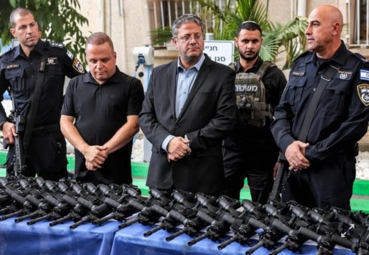 Israeli Occupation Police Minister, Itamar Ben-Gvir, distributing US rifles to settlers in the West Bank, (AFP via Getty Images)