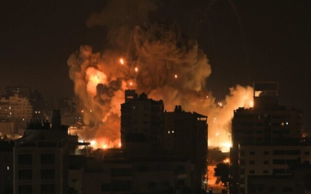 Fire and smoke rise above residential buildings in Gaza City during an Israeli airstrike on October 8, 2023 (AFP)