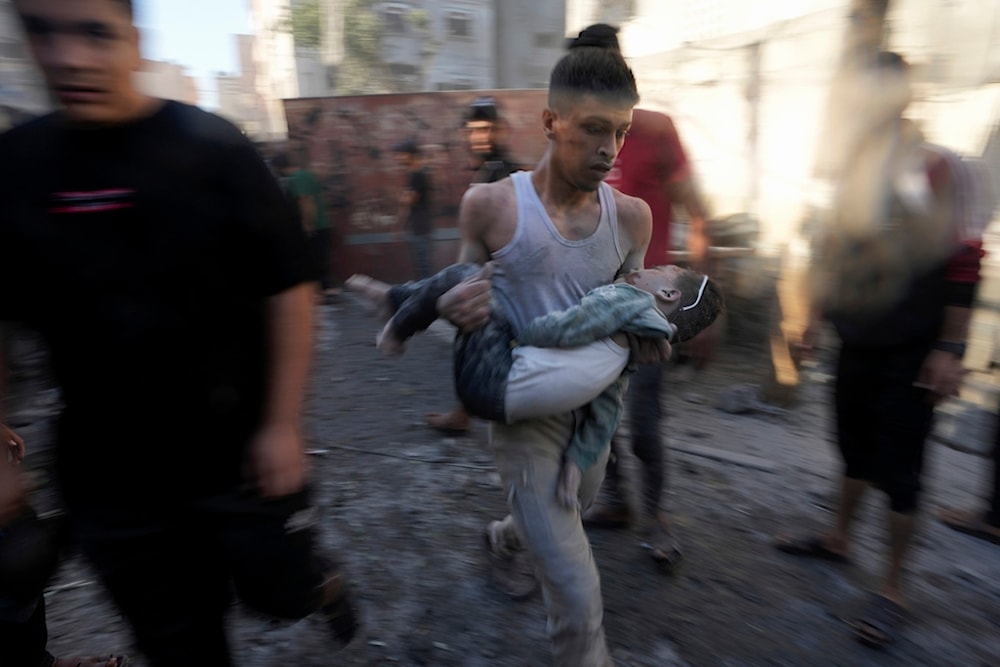 Palestinians evacuate survivors after Israeli airstrikes on buildings in Deir al Balah, Gaza Strip, Palestine, Tuesday, Nov. 7, 2023  (AP Photo/Adel Hana)
