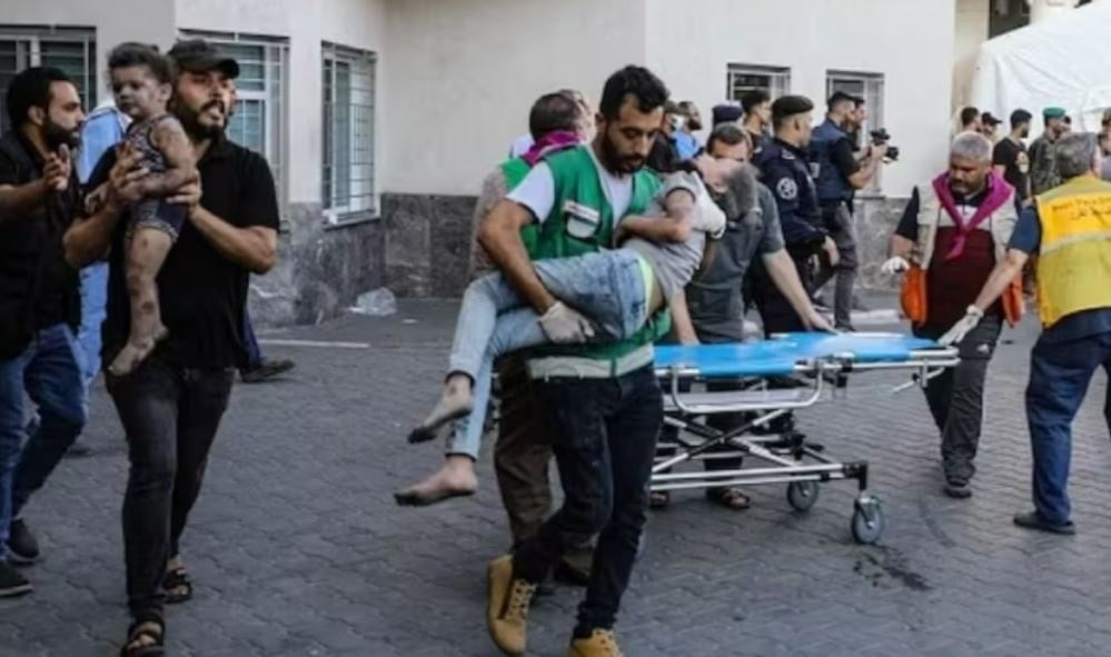 Children injured in an Israeli strike are rushed to al-Shifa hospital in Gaza City. (AFP via Getty Images)