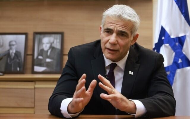 Foreign Minister Yair Lapid during an interview at his office (AFP)