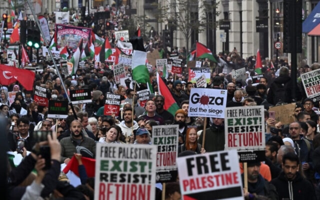 People walk down Regent Street as they take part in a 'March For Palestine' in London on October 14, 2023. (AFP)