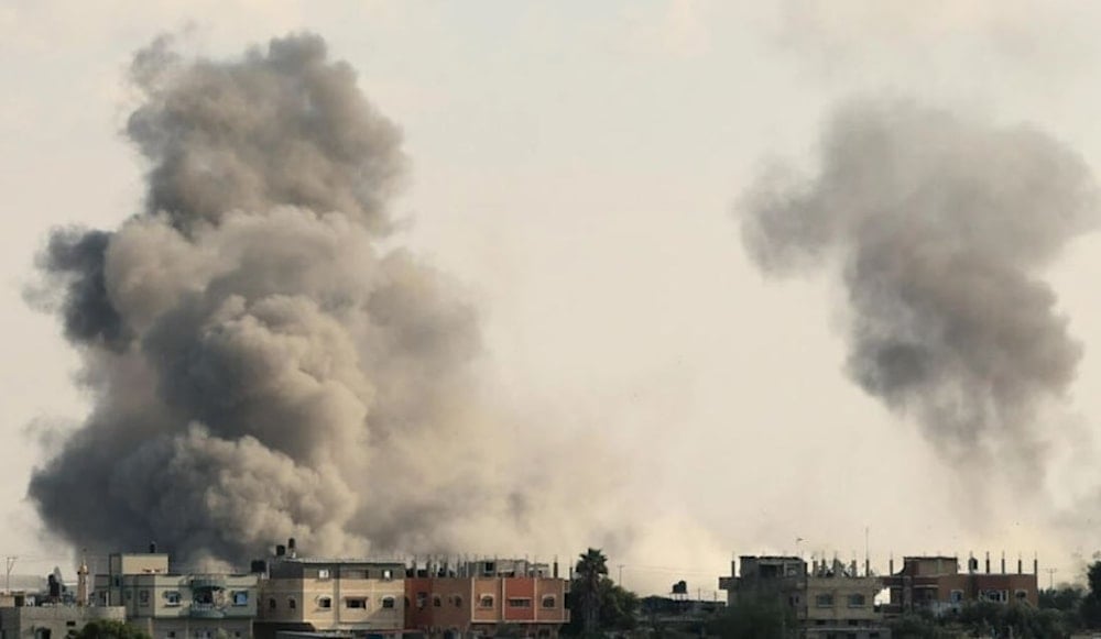 Smoke billows over Gaza's Rafah border crossing with Egypt its only one that bypasses “Israel” following an Israeli air strike. (AFP)