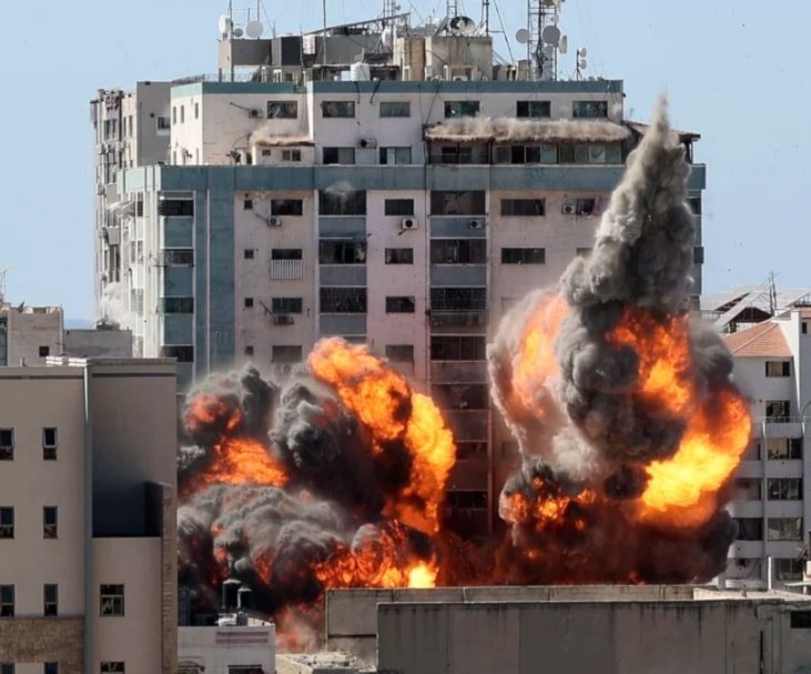 A ball of fire erupts from a building housing various international media, including AP, after an Israeli airstrike in Gaza City. (AP)