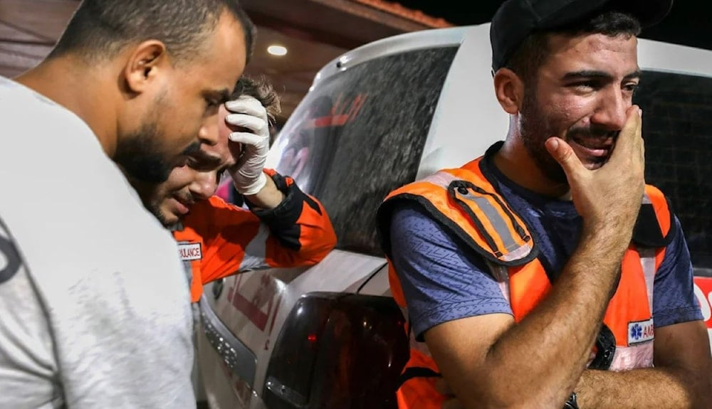 Palestinian paramedics cry due to witnessing Israeli atrocities outside al-Shifa hopsital in Gaza City on October 16. (AFP via Getty Images)