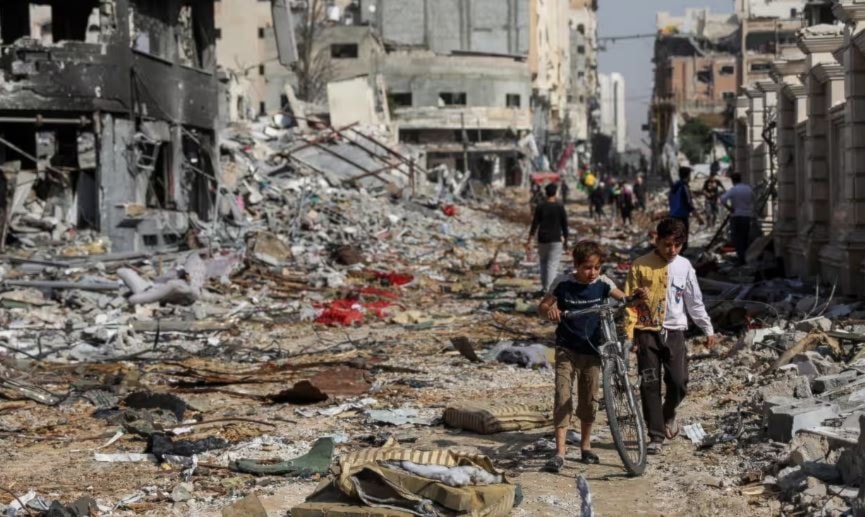 Palestinian children walk through destruction due to brutal Israeli airstrikes on residential areas in Gaza last week. (AP)