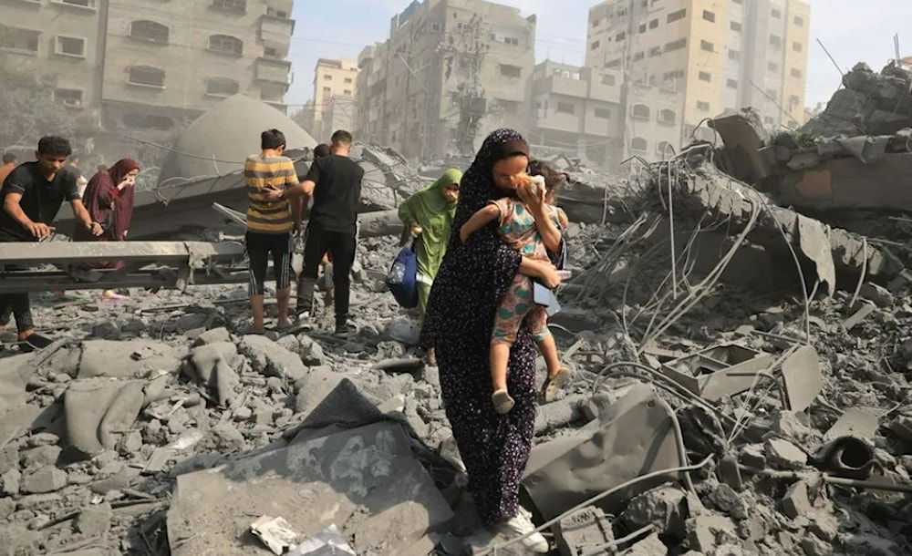 Palestinian mom holding her baby following an Israeli airstrike on the Sousi Mosque in Gaza on Oct. 9. (AFP via GETTY IMAGES)