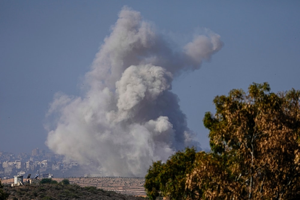 Smoke rises following an Israeli airstrike in the Gaza Strip, as seen from southern Palestine, Friday, Dec. 1, 2023. (AP Photo/Ariel Schalit)