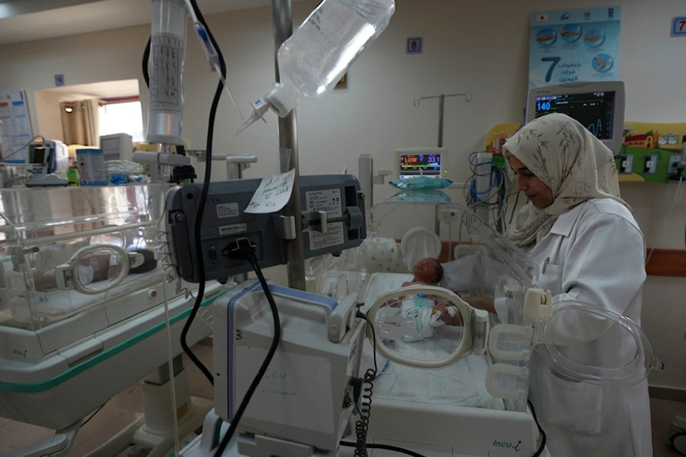 A Palestinian doctor treats a prematurely born baby at Al Aqsa Hospital in Deir al Balah, Gaza Strip, Sunday, Dec. 10, 2023. (AP Photo/Adel Hana)