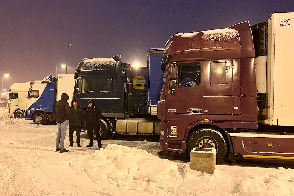 Ukrainian truck drivers wait to cross from Poland back into Ukraine in Korczowa, Poland, on Thursday Dec. 7, 2023. (AP)