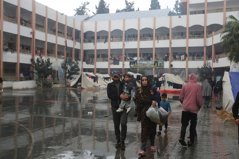 Displaced Palestinians walk inside a UN-run school, Gaza Strip, on Monday, Nov. 27, 2023. (AP)