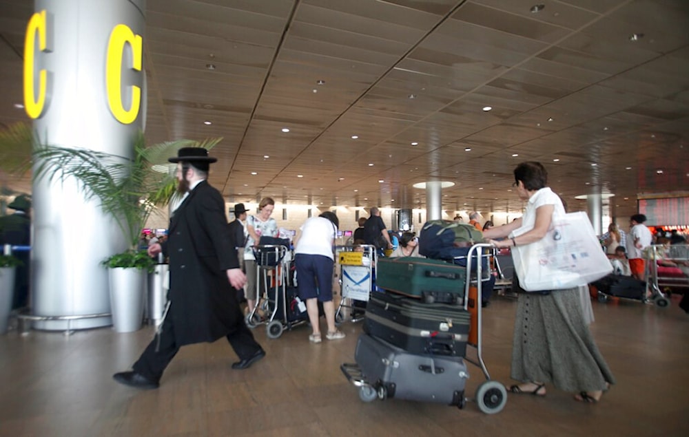 Israelis move through the departure terminal at Ben-Gurion International Airport in Tel Aviv Thursday, July 19, 2012 (AP)