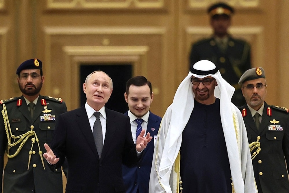 Emirati President Sheikh Mohammed bin Zayed Al Nahyan, foreground right, and Russian President Vladimir Putin, foreground left, attend an official welcome ceremony at Qasr Al Watan, Abu Dhabi, United Arab Emirates, Wednesday, Dec. 6, 2023 (AP)