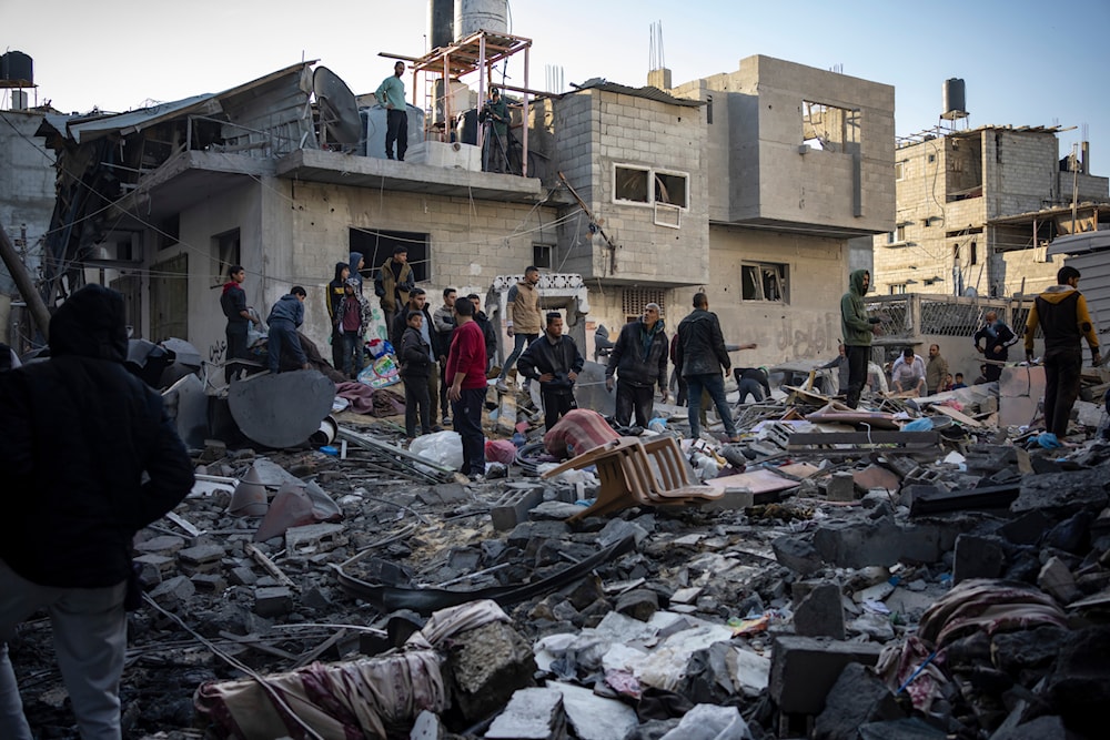 Palestinians look at houses destroyed in the Israeli bombardment of the Gaza Strip in Rafah on Saturday, Dec. 9, 2023. (AP)