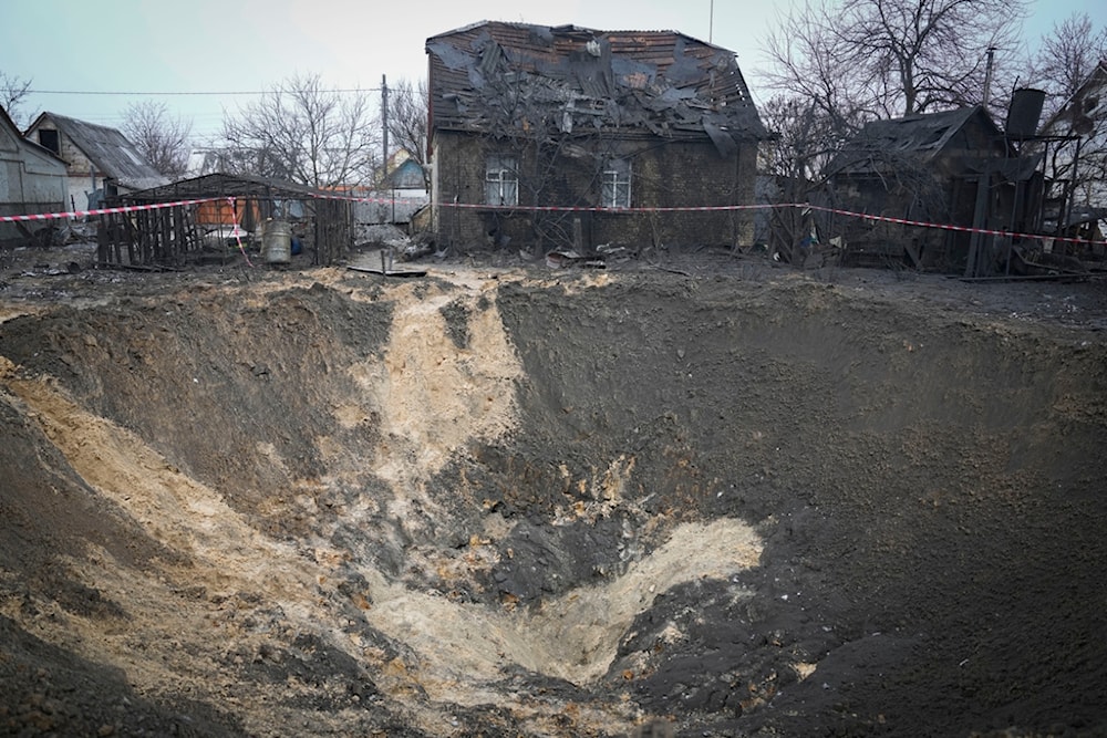 A general view of the crater at a site of recent missile attack in Kiev, Ukraine, Monday, Dec. 11, 2023. (AP Photo/Efrem Lukatsky)
