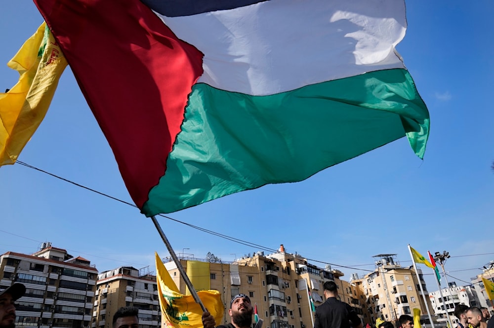  Hezbollah supporter waves a Palestinian flag in Beirut, Lebanon on November 3, 2023 (AP)