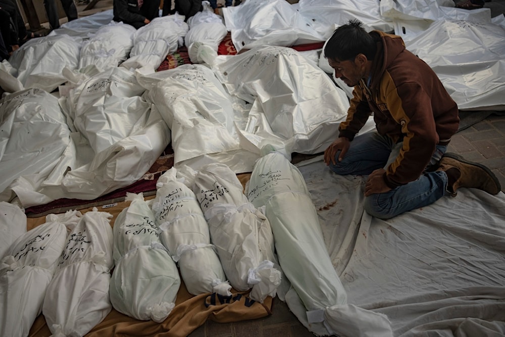 Palestinians mourn their relatives killed in the Israeli bombardment of the Gaza Strip, at the hospital Rafah, Gaza, Tuesday, Dec. 12, 2023. (AP Photo/Fatima Shbair)