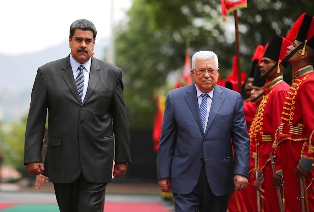 President Nicolas Maduro, left, walks with Palestinian President Mahmud Abbas on May 7, 2018 (AP)