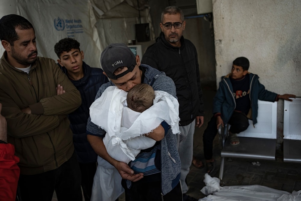 Palestinians mourn their relatives killed in the Israeli bombardment of the Gaza Strip, at the hospital Rafah, Gaza, Tuesday, Dec. 12, 2023. (AP Photo/Fatima Shbair)
