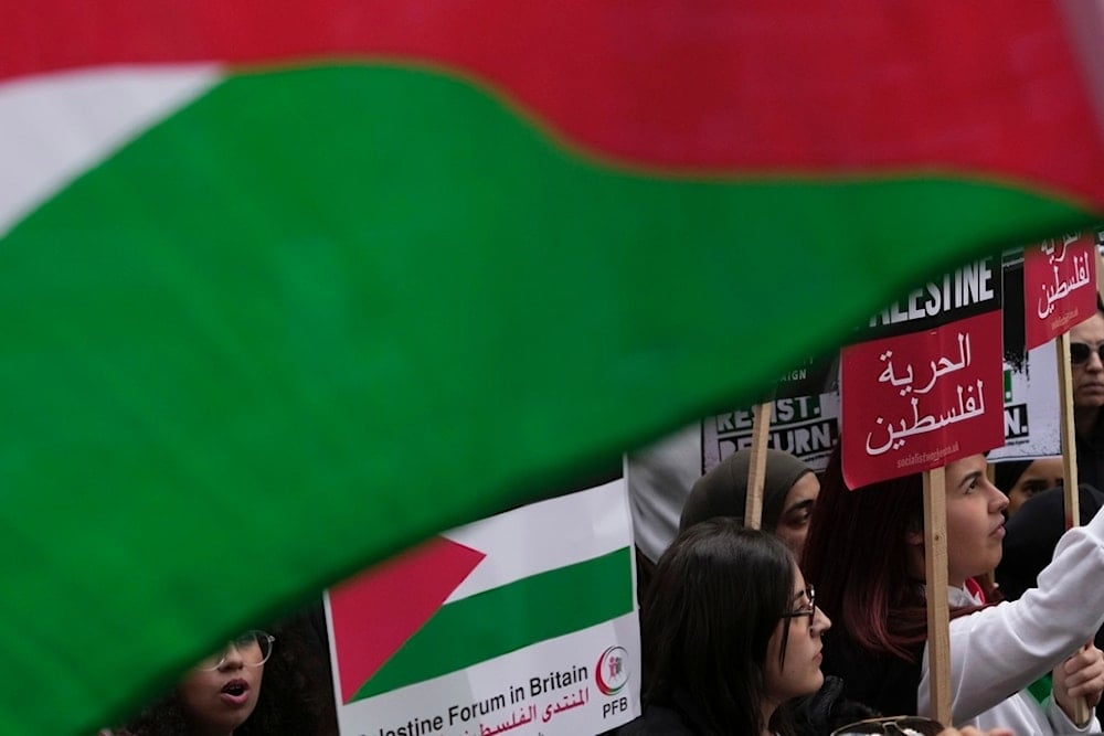 Protesters march during a pro Palestinian demonstration in London, Saturday, Oct. 14, 2023 (AP)