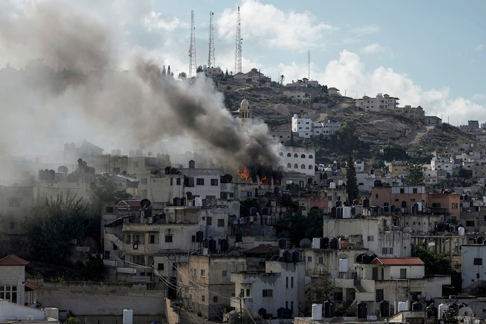 Fire and smoke rises during an IOF aggression on Jenin, occupied West Bank, Wednesday, Dec. 13, 2023. (AP Photo/Majdi Mohammed)