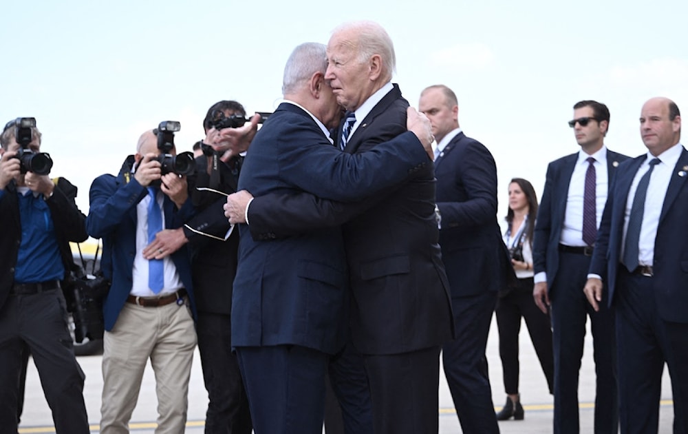 Israeli occupation’s Prime Minister Benjamin Netanyahu hugs US President Joe Biden upon his arrival at “Tel Aviv” on October 18, 2023.