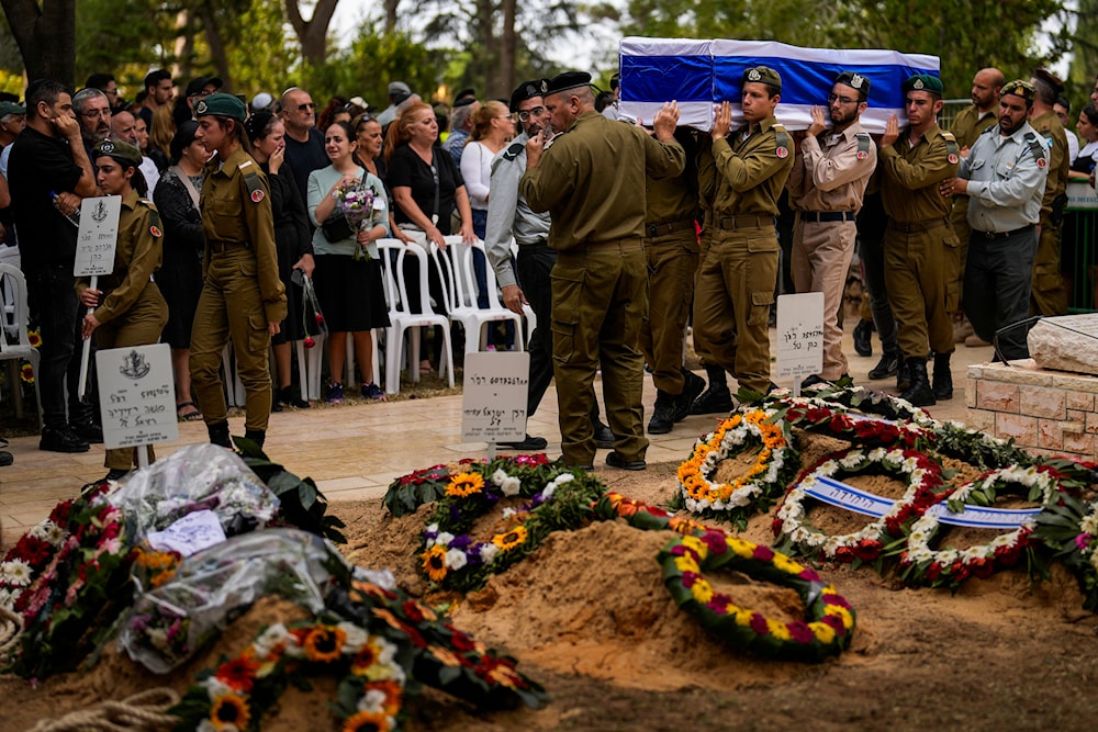Israeli soldiers carry the flag-covered coffin of Abraham Cohen at the Mount Herzl cemetery in al-Quds, Thursday, Oct. 12, 2023. (AP)
