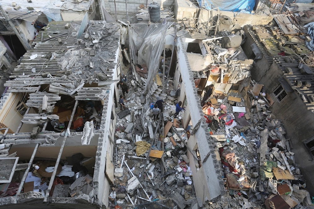 Palestinians salvage belongings after an Israeli air strike targeting residential buildings in Rafah, Gaza Strip, on Thursday, Dec. 14, 2023. (AP)
