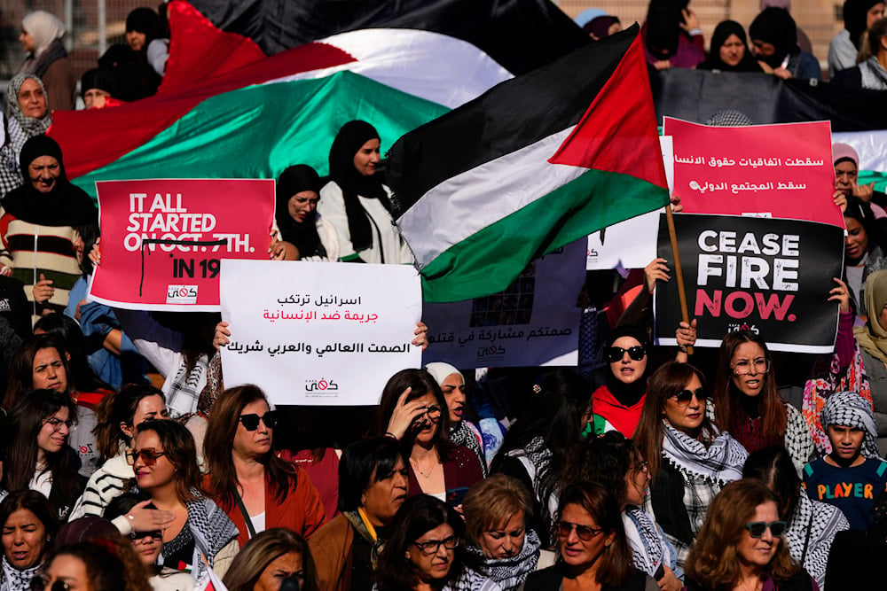 Protesters hold Palestinian flag during a protest in solidarity with the Palestinian people in Gaza, in front of the headquarters of U.N. Economic and Social Commission for Western Asia (ESCWA), in Beirut, Lebanon, Wednesday, Nov. 29, 2023. (AP)