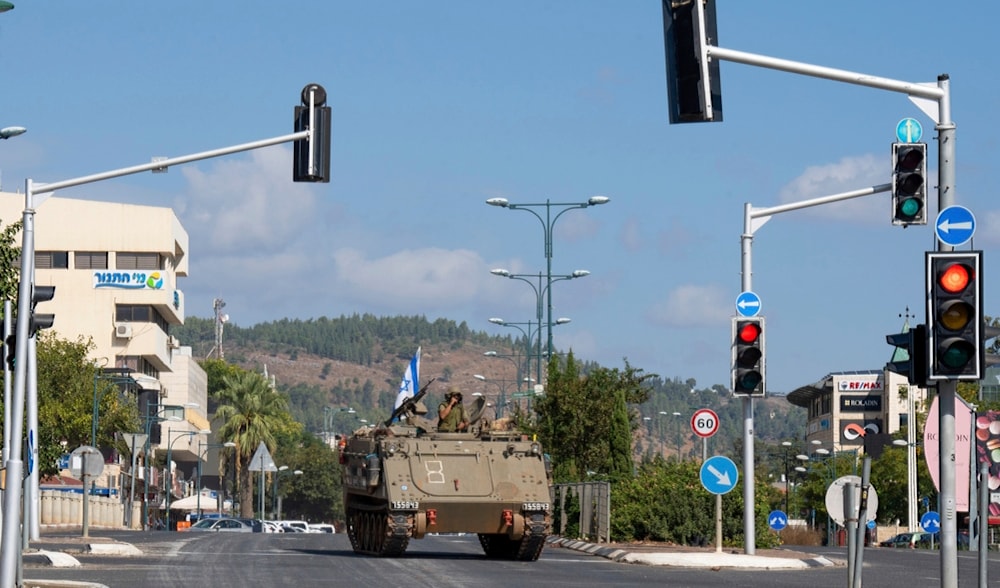 Israeli occupation forces drive an armored personal carrier (APC) in the northern Israeli settlement of Kiryat Shmona, Friday, Oct. 20, 2023. (AP)