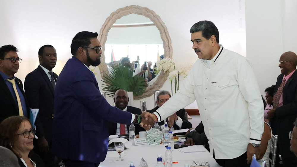 This handout picture released by the Venezuelan Presidency shows Venezuelas President Nicolas Maduro with Guyana’s President Irfaan Ali in Saint Vincent and The Grenadines on Dec. 14, 2023. (AFP)